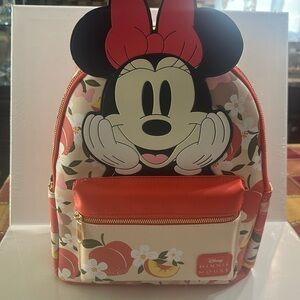 NWOT Disney Minnie Mouse Backpack with front/side pocket and zipper closure.